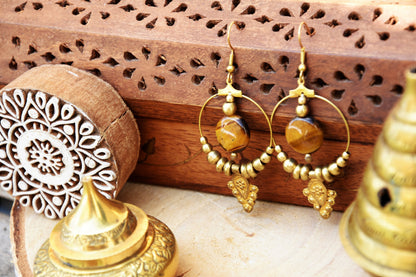 Golden brass Tiger eye earrings with tribal charm