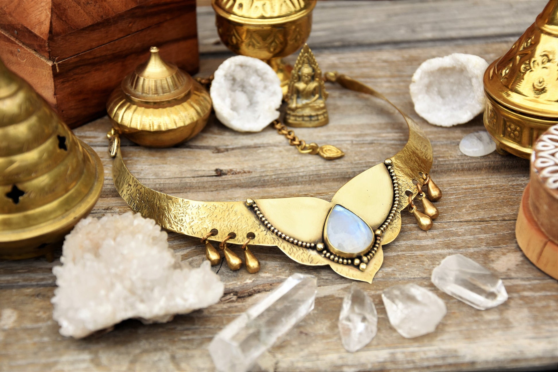 Golden torque necklace with a Moonstone crystal and tribal drop charms