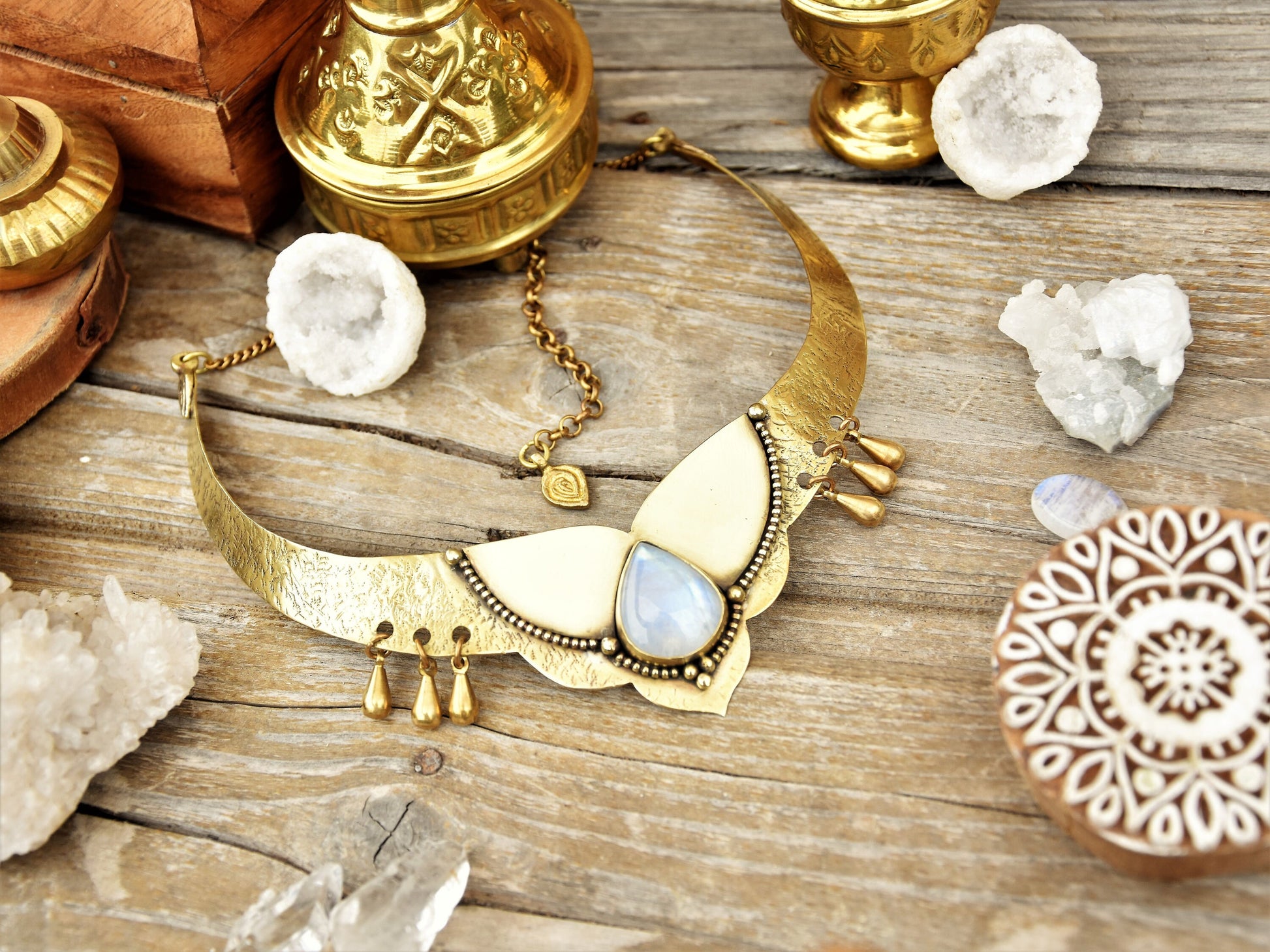 Golden torque necklace with a Moonstone crystal and tribal drop charms