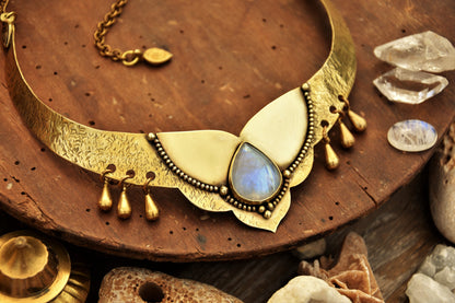 Golden torque necklace with a Moonstone crystal and tribal drop charms