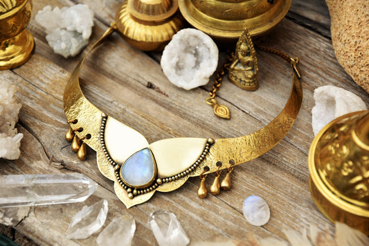 Golden torque necklace with a Moonstone crystal and tribal drop charms