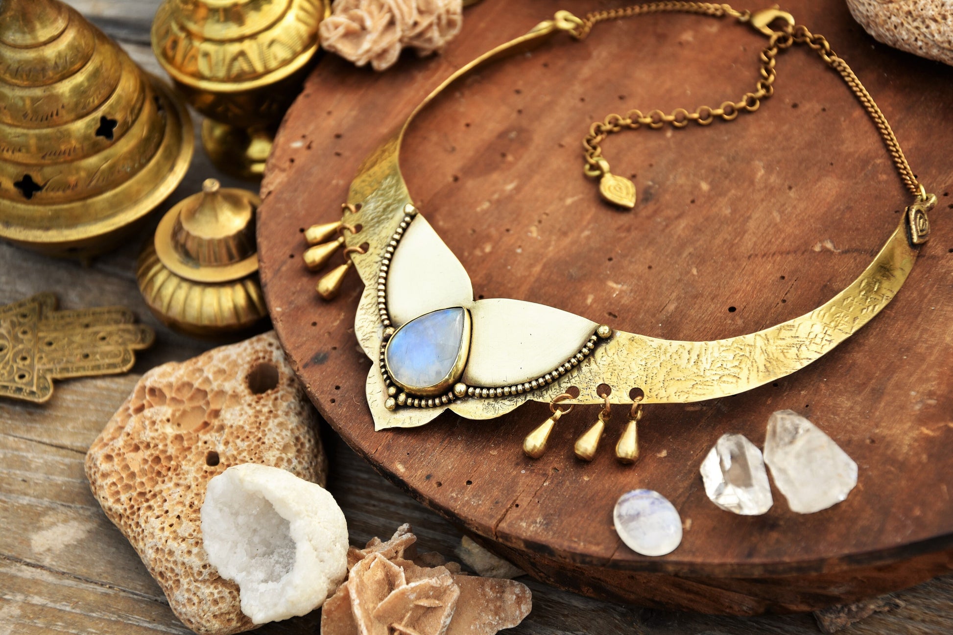 Golden torque necklace with a Moonstone crystal and tribal drop charms