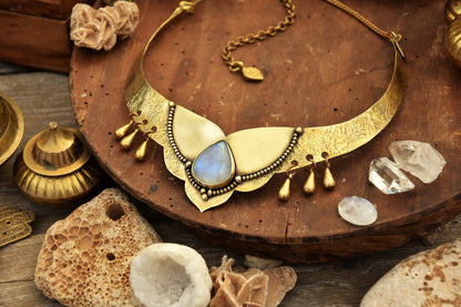 Golden torque necklace with a Moonstone crystal and tribal drop charms