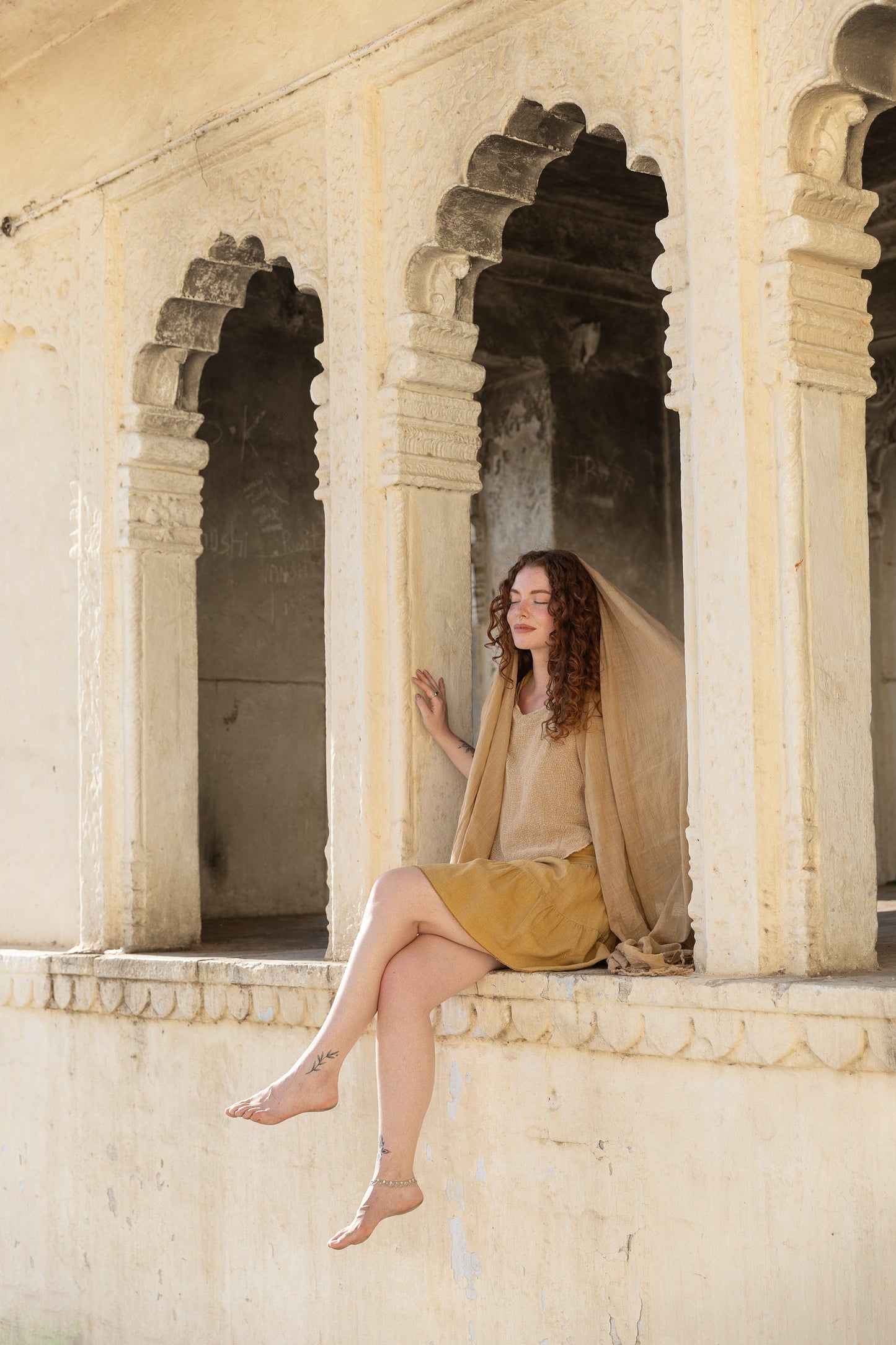 large bohemian scarf with fringes on each side and made from raw beige cotton